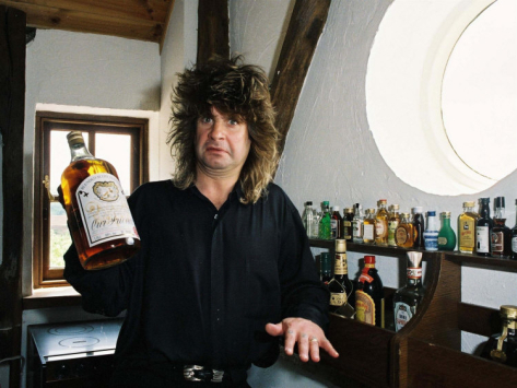black-sabbath-singer-ozzy-osbourne-holding-a-large-bottle-of-whiskey-at-his-home-in-1988_i-G-29-2971-C2HQD00Z