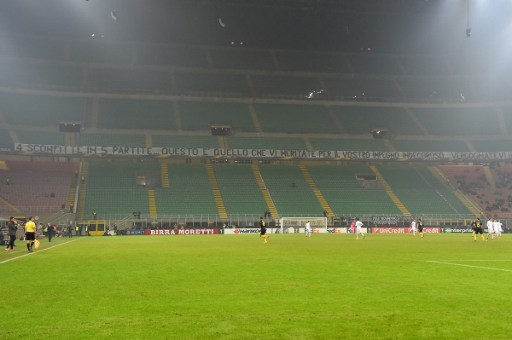 Inter Milan and Sparta Praha football teams play in front of an empty tribune with a banner reading "four defeats in five matches, this is what you deserved for your undignified dedication...shame on you" to protest against the Inter results during the UEFA Europa League football match between Inter Milan and Sparta Praha at the San Siro Stadium, in Milan, on December 8, 2016. Inter Milan and Sparta Praha football teamms play in front of an empty tribune with a banner reading "four defeates in five matches, this is what you deserved for your undignified dedication...shame on you" to protest against the Inter results during the UEFA Europa League football match between Inter Milan and Sparta Praha at the San Siro Stadium, in Milan, on December 8, 2016. / AFP PHOTO / GIUSEPPE CACACE
