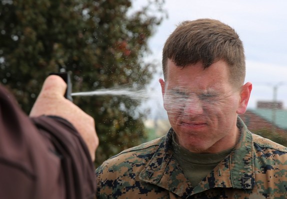 Lance Cpl. Dakota Jankowski gets sprayed with Oleoresin Capsicum, a potent pepper spray-like chemical during an obstacle course at Marine Corps Air Station Cherry Point, N.C, March 6, 2015. Marines with the Provost Marshal’s Office must complete the obstacle course while under the effects of OC spray in order to pass the exercise. Jankowski is a student in the block training course for PMO guards and a native of Camano Isle, Wash.